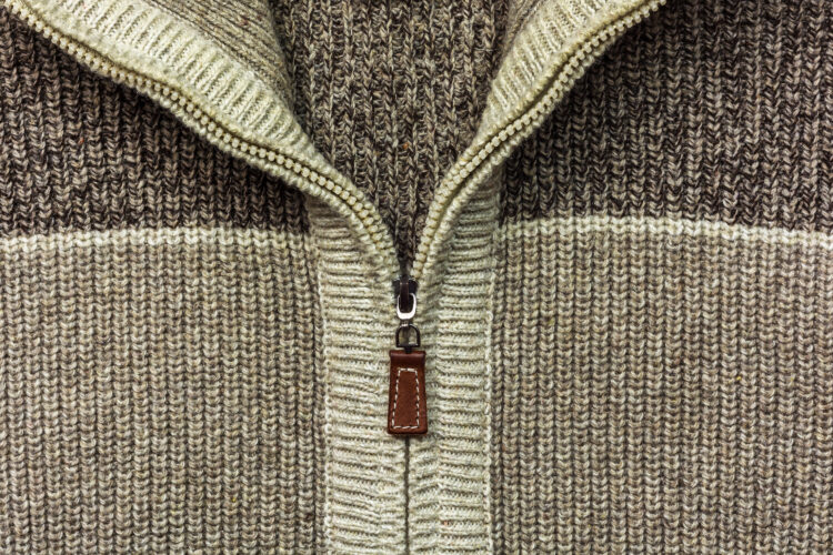 Background, texture, structure, zipper sewn into woolen fabric Svetlyak shades