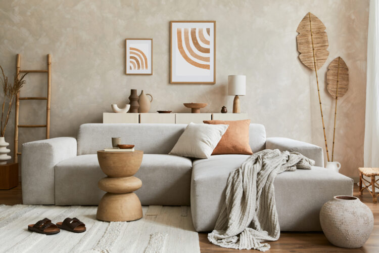 Elegnat living room interior design with mock up poster frame, grey corner sofa, coffee table and personal accessories. Pastel neutral colours. Template.